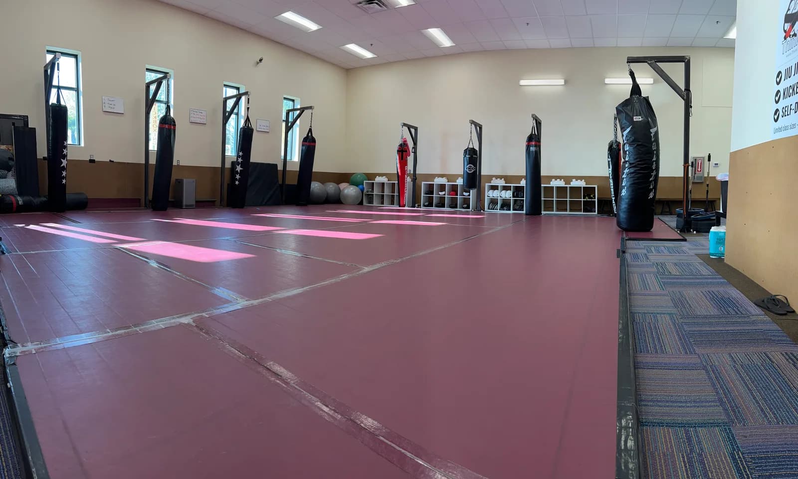 Kickboxing gym interior with mats and heavy bags at ThinkTank in Vancouver, WA — where women’s kickboxing classes are held